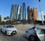 Comfortable car lift from Dubai to Abu Dhabi with city skyline in background auto car lifts