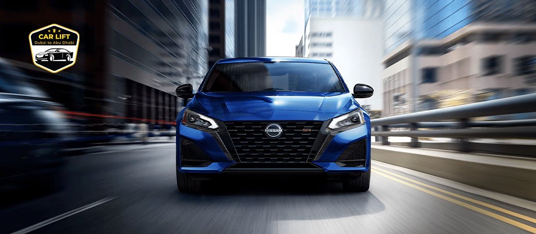 Blue Nissan sedan driving through a modern city street, with the 'Car Lift Dubai to Abu Dhabi' logo in the top-left corner